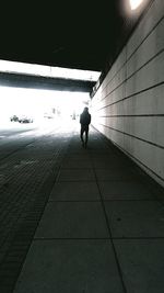 Rear view of silhouette woman walking on road