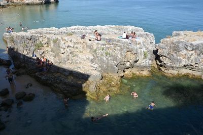 High angle view of people swimming in sea