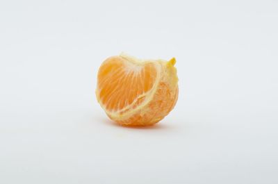 Close-up of orange slice against white background