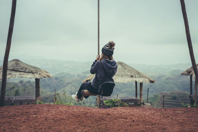 Full length of woman on swing at playground