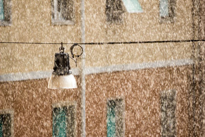 Close-up of chain hanging against wall