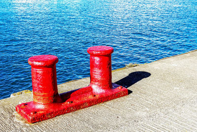 High angle view of red metallic bollard on pier