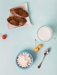 Cottage cheese in a blue bowl with sour cream and honey.