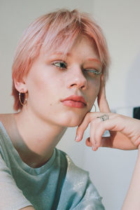 Close-up portrait of young woman at home