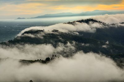 Scenic view of sea and mountains against sky