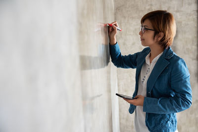 Woman writing on wall