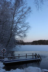 Scenic view of lake against clear sky during winter