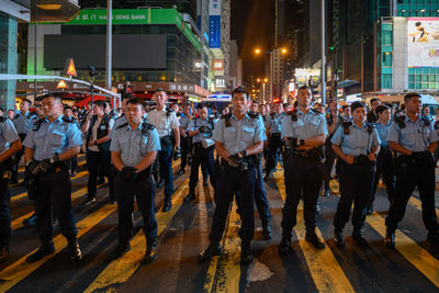 Group of people on city street at night