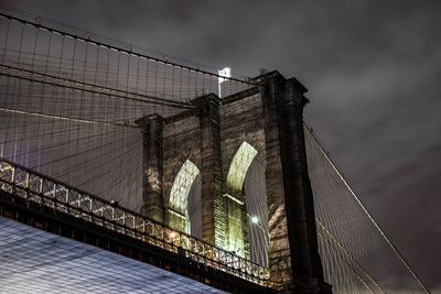 Low angle view of illuminated brooklyn bridge against sky at night