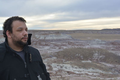 Thoughtful man looking away at painted desert