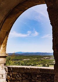 View of blue sky seen through arch