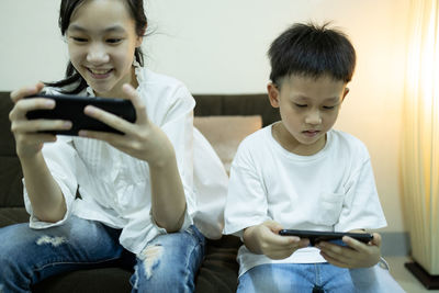Boy sitting on mobile phone