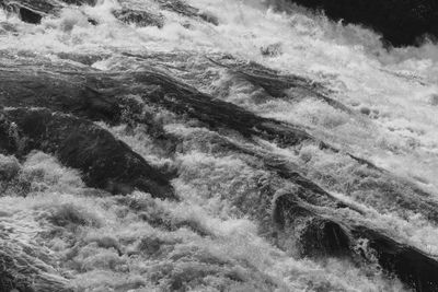High angle view of water flowing through rocks