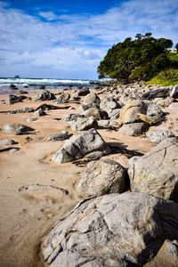 Rocks on beach against sky