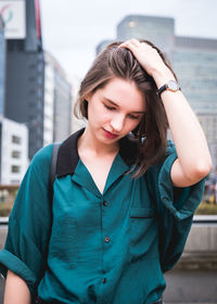 Beautiful young woman standing in city