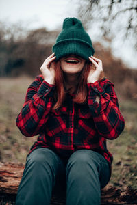 Portrait of young woman wearing hat