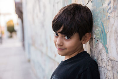 Portrait of teenage boy looking at wall