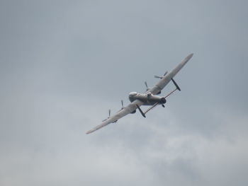 Low angle view of fighter plane flying in sky