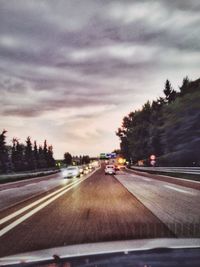 Road against cloudy sky at sunset