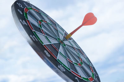 Low angle view of dartboard against sky