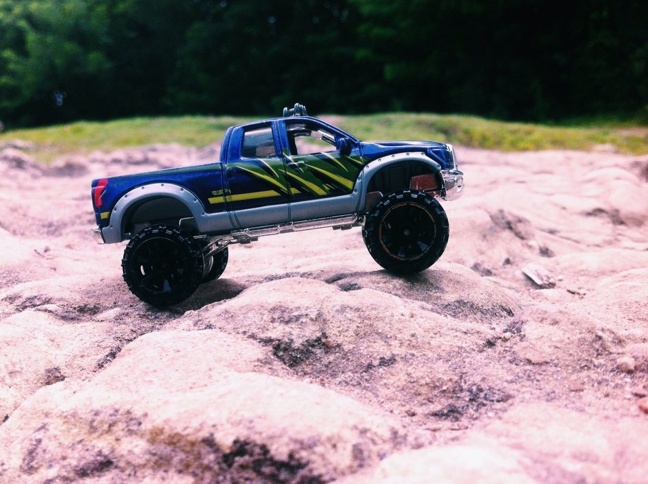 transportation, land vehicle, mode of transport, field, car, abandoned, outdoors, stationary, close-up, day, toy, no people, sand, sunlight, childhood, nature, damaged, focus on foreground, selective focus, wheel