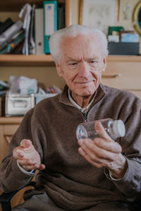 Portrait of man sitting at home