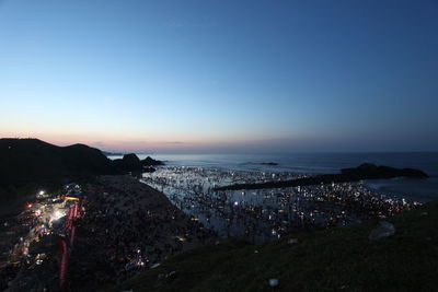 Aerial view of city lit up at night