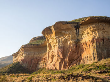 Low angle view of rock formation against clear sky