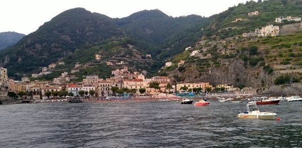 Boats in river with town in background