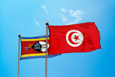 Flags against blue sky