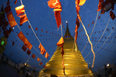 Low angle view of religious structure against blue sky