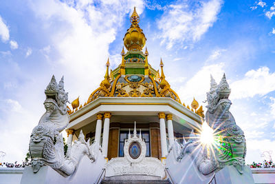 Low angle view of temple against building against sky