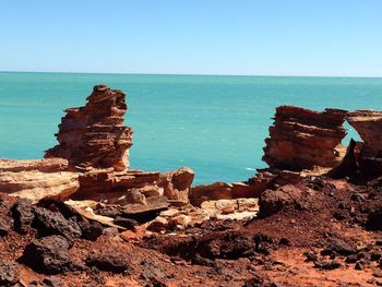 Scenic view of sea against clear blue sky