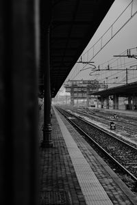 Train at railroad station platform against sky