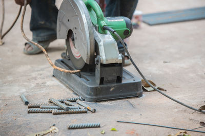 Low section of man using circular saw