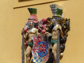 Close-up of figurine sculpture against wall