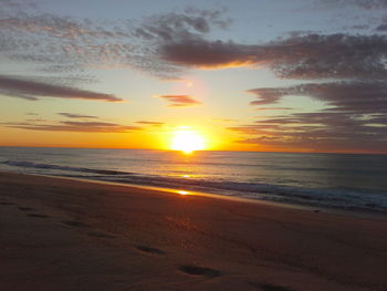 Scenic view of beach against sky during sunset