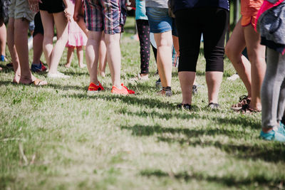 Low section of people standing on field