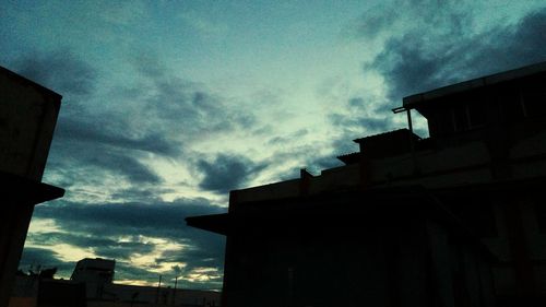 Low angle view of buildings against sky at sunset