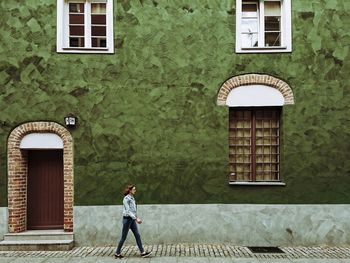 Man standing on brick wall