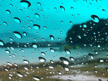 Full frame shot of wet glass window in rainy season