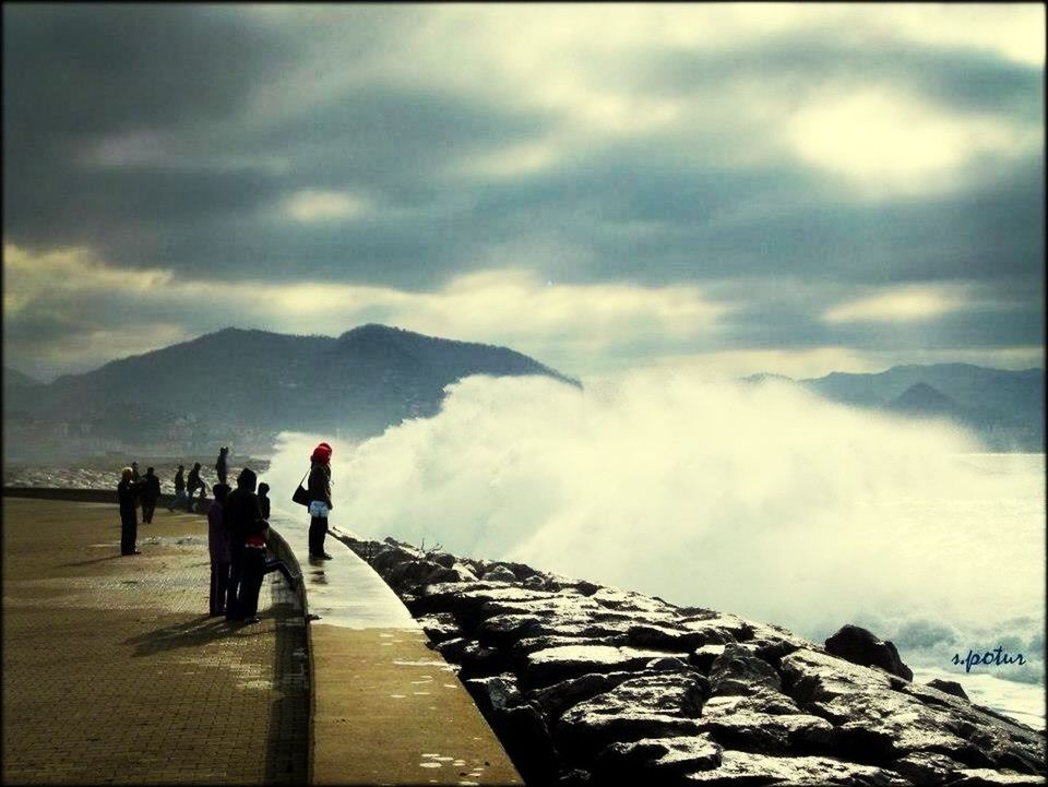 mountain, sky, lifestyles, cloud - sky, men, leisure activity, mountain range, cloudy, full length, person, cloud, rear view, standing, railing, tourist, walking, transfer print, auto post production filter