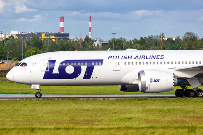 Information sign on airport runway against sky