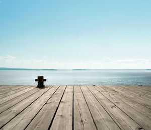 Rear view of woman standing on pier against sky