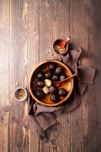 Traditional indian sweets. sweet gulab jamun in wooden bowl on rustic background