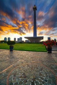 View of monument in city against cloudy sky