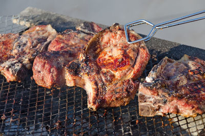 High angle view of meat on barbecue grill