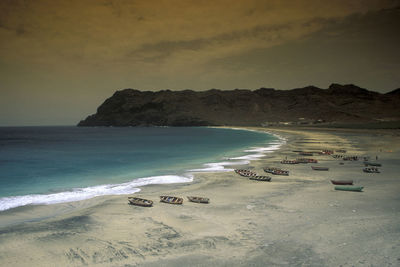 Scenic view of beach against sky during sunset