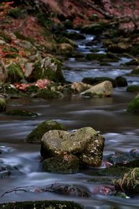 Close-up of stream flowing amidst rocks