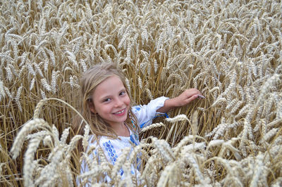 Portrait of smiling girl on wheat field
